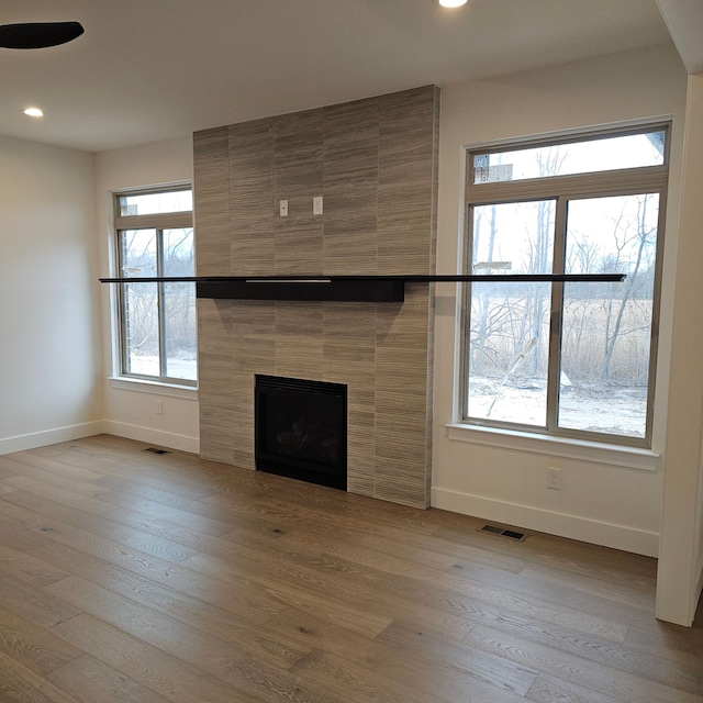 50638 Mistwood Dr, Macomb, MI 48042 - unfurnished living room with baseboards, recessed lighting, a fireplace, and wood finished floors