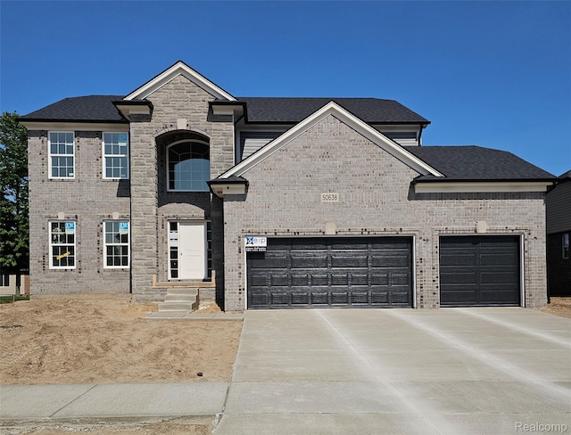 50638 Mistwood Dr, Macomb, MI 48042 - french country inspired facade featuring concrete driveway, an attached garage, brick siding, and roof with shingles