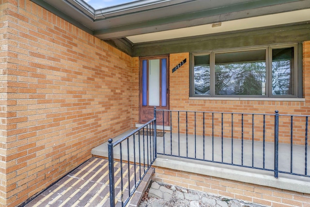 view of exterior entry featuring brick siding