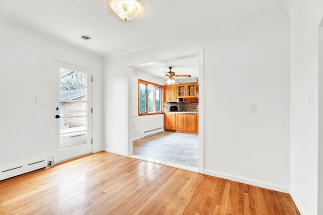 foyer entrance with ceiling fan, baseboard heating, light wood-style flooring, baseboards, and a baseboard heating unit