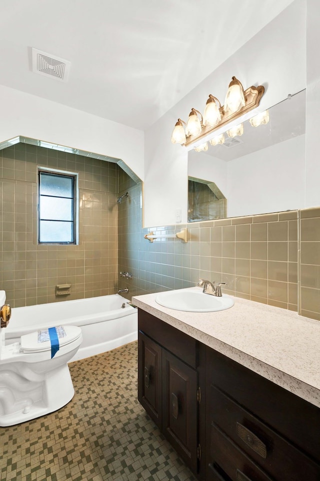 full bathroom featuring visible vents, vanity, tile patterned floors, toilet, and bathing tub / shower combination