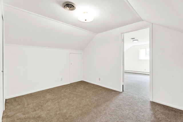 additional living space featuring carpet floors, visible vents, baseboards, baseboard heating, and vaulted ceiling