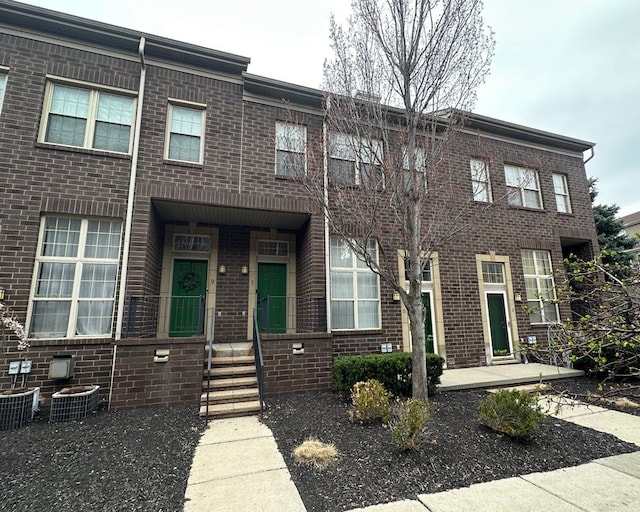 multi unit property with brick siding and cooling unit