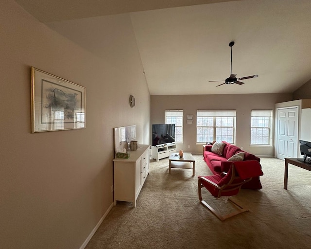 living area with a ceiling fan, baseboards, high vaulted ceiling, and light colored carpet