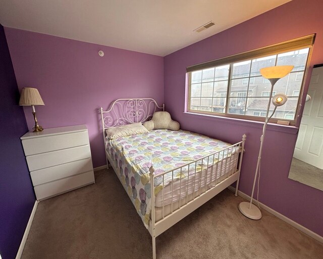 bedroom featuring visible vents, carpet flooring, and baseboards