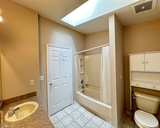 full bathroom with visible vents, toilet, a sink, a skylight, and shower / tub combo