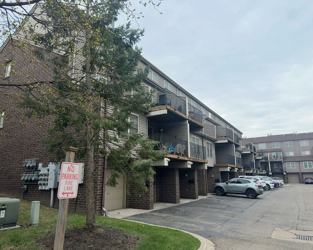 view of building exterior with uncovered parking