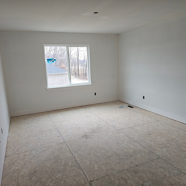 empty room featuring baseboards