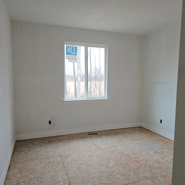 empty room with baseboards and visible vents