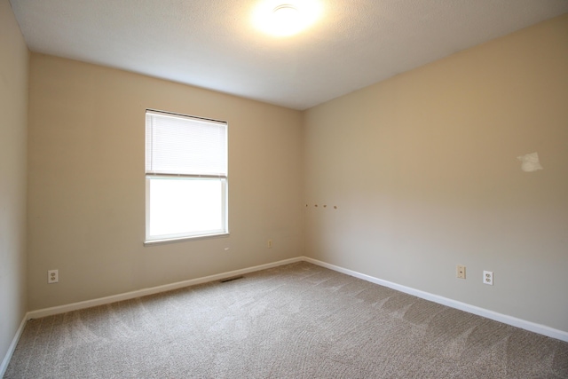 1154 Martin Dr, Frankfort, MI 49635 - empty room featuring visible vents, baseboards, and carpet flooring