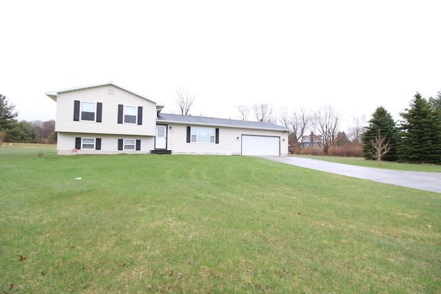 1154 Martin Dr, Frankfort, MI 49635 - split level home with concrete driveway, a front lawn, and a garage