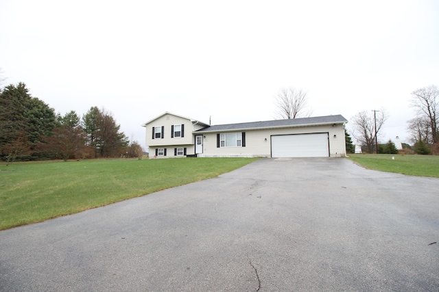 1154 Martin Dr, Frankfort, MI 49635 - split level home with a garage, a front yard, and aphalt driveway