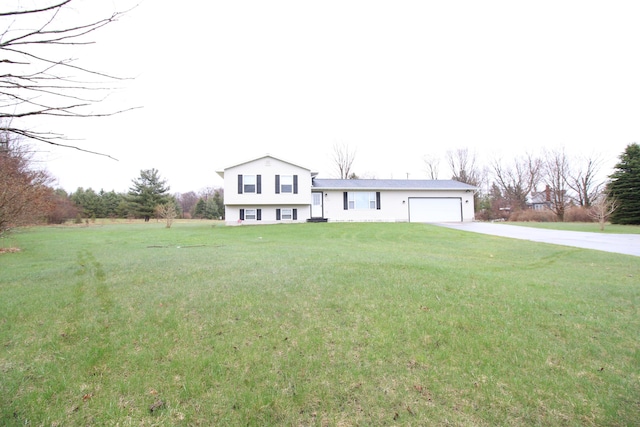 1154 Martin Dr, Frankfort, MI 49635 - split level home featuring an attached garage, a front yard, and concrete driveway