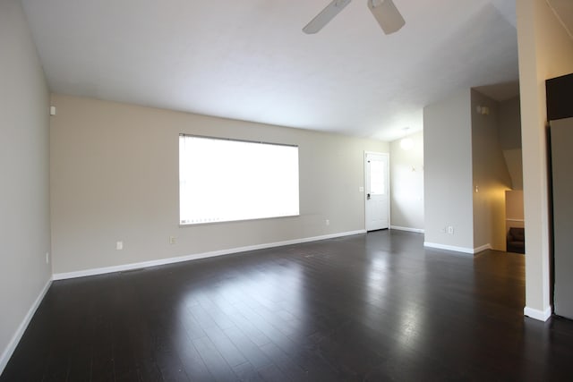1154 Martin Dr, Frankfort, MI 49635 - unfurnished living room featuring baseboards, ceiling fan, and dark wood finished floors