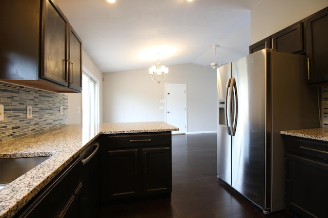 1154 Martin Dr, Frankfort, MI 49635 - kitchen featuring vaulted ceiling, tasteful backsplash, stainless steel fridge with ice dispenser, dark wood finished floors, and a peninsula