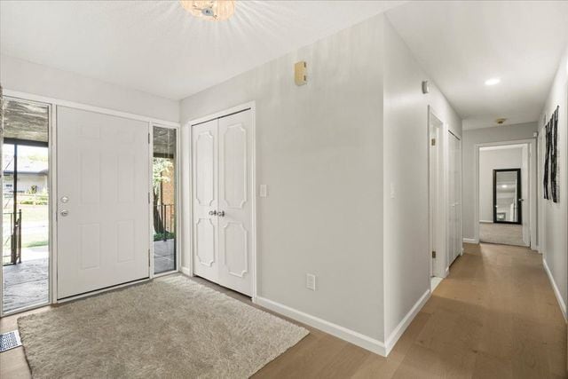entryway featuring light wood finished floors and baseboards
