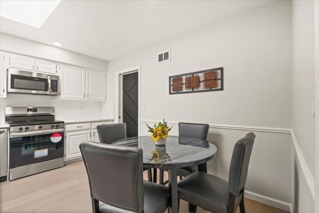 dining area with visible vents, recessed lighting, and light wood-style floors