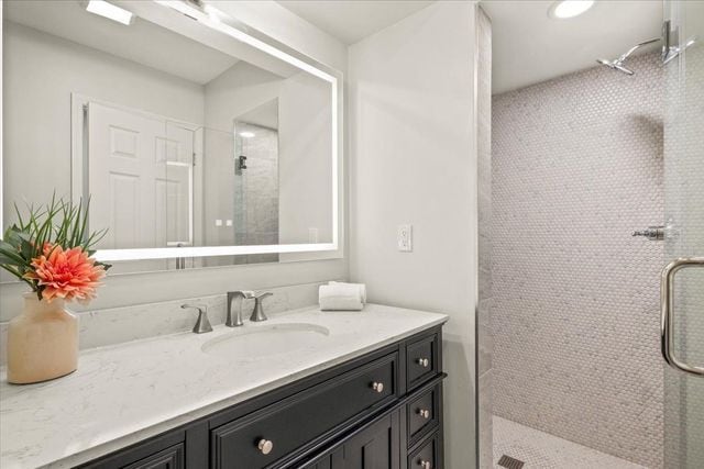 full bath with vanity and a stall shower