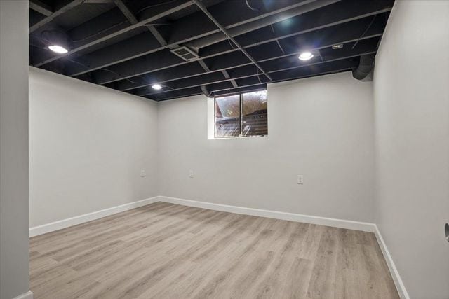 basement featuring wood finished floors and baseboards