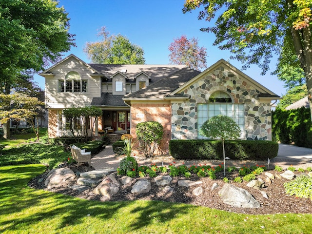 14165 Bournemuth Dr, Shelby Twp, MI 48315 - view of front of home with brick siding, stone siding, a shingled roof, and a front yard