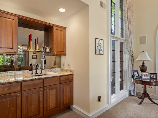 14165 Bournemuth Dr, Shelby Twp, MI 48315 - bar with light colored carpet, baseboards, a sink, and visible vents