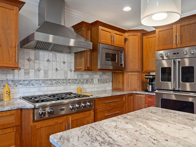 14165 Bournemuth Dr, Shelby Twp, MI 48315 - kitchen featuring wall chimney range hood, tasteful backsplash, light stone countertops, brown cabinetry, and appliances with stainless steel finishes