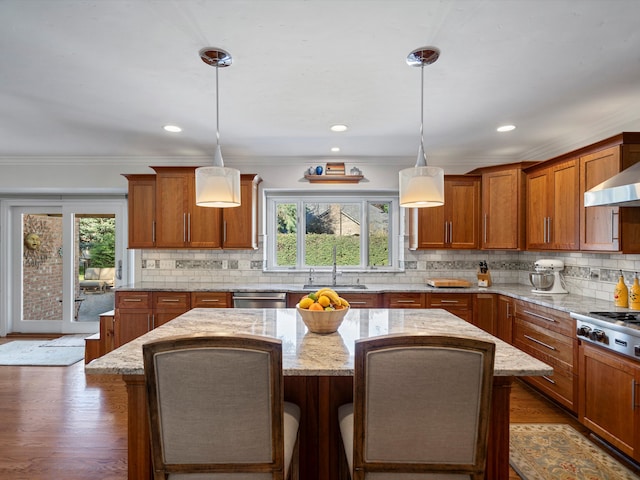 14165 Bournemuth Dr, Shelby Twp, MI 48315 - kitchen featuring brown cabinetry, a kitchen island, appliances with stainless steel finishes, and a sink