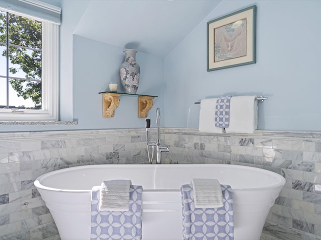 14165 Bournemuth Dr, Shelby Twp, MI 48315 - full bath featuring marble finish floor, vaulted ceiling, a wainscoted wall, and tile walls