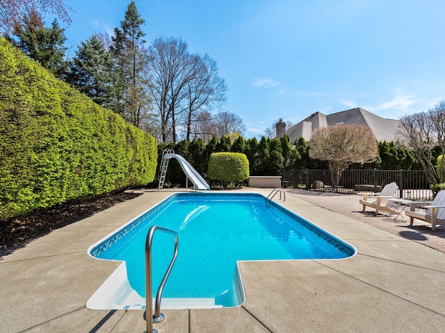 14165 Bournemuth Dr, Shelby Twp, MI 48315 - view of swimming pool featuring a patio area, a water slide, a fenced in pool, and fence