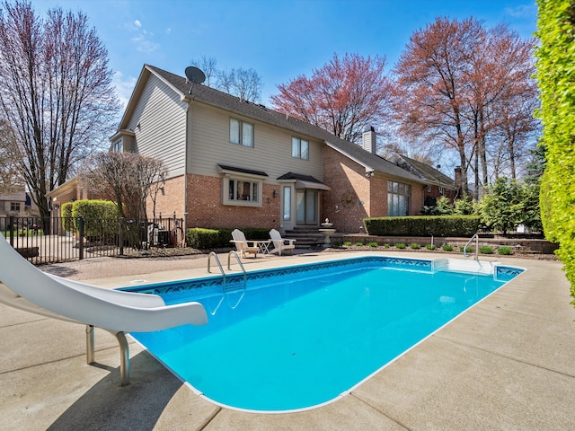 14165 Bournemuth Dr, Shelby Twp, MI 48315 - view of pool with fence, a fenced in pool, and a water slide