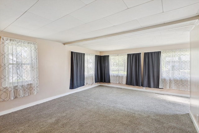 carpeted empty room featuring baseboards