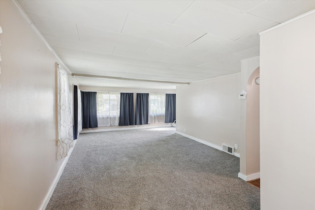carpeted spare room featuring baseboards