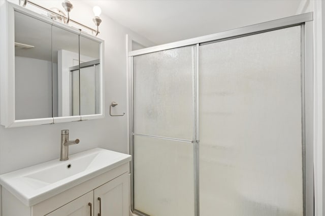 bathroom with a stall shower and vanity