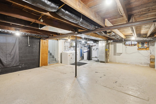 unfinished basement with washer and dryer, heating unit, stairs, and water heater