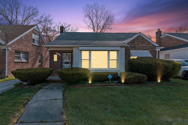 9226 Grandville Ave, Detroit, MI 48228 - view of front of property featuring brick siding, a yard, and a chimney