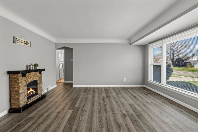 9226 Grandville Ave, Detroit, MI 48228 - unfurnished living room featuring dark wood finished floors, baseboards, a stone fireplace, and visible vents