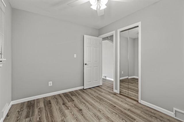 9226 Grandville Ave, Detroit, MI 48228 - unfurnished bedroom with baseboards, wood finished floors, visible vents, and a closet