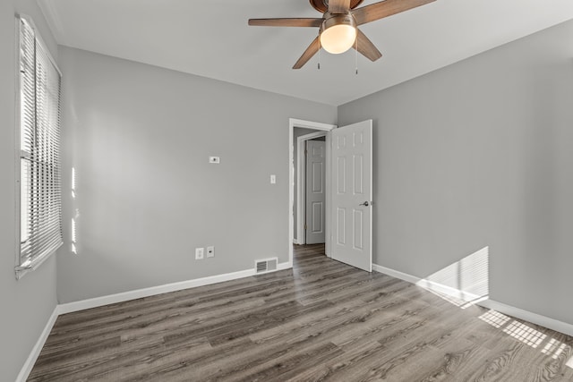9226 Grandville Ave, Detroit, MI 48228 - unfurnished bedroom featuring baseboards, a ceiling fan, wood finished floors, and visible vents