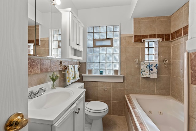 9226 Grandville Ave, Detroit, MI 48228 - bathroom featuring toilet, a jetted tub, tile patterned flooring, and tile walls