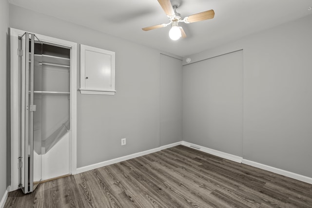 9226 Grandville Ave, Detroit, MI 48228 - unfurnished bedroom featuring baseboards, dark wood-type flooring, and ceiling fan