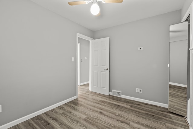 9226 Grandville Ave, Detroit, MI 48228 - unfurnished bedroom featuring wood finished floors, visible vents, baseboards, and ceiling fan