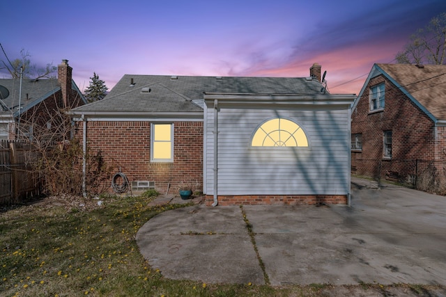9226 Grandville Ave, Detroit, MI 48228 - back of house featuring brick siding, roof with shingles, fence, and a patio area