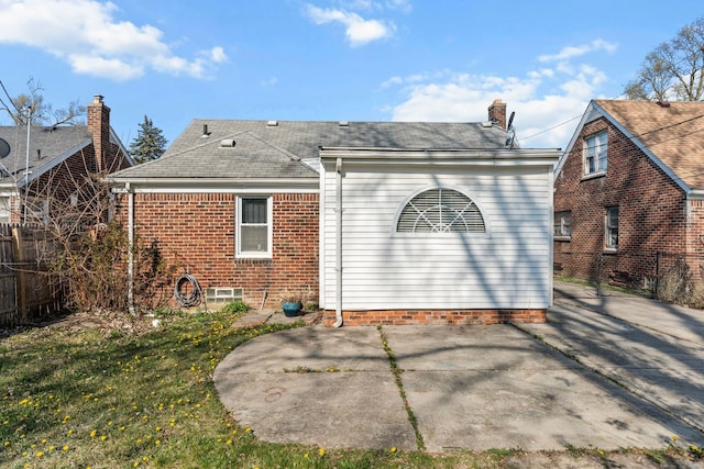 9226 Grandville Ave, Detroit, MI 48228 - back of property featuring a chimney, fence, roof with shingles, and a patio
