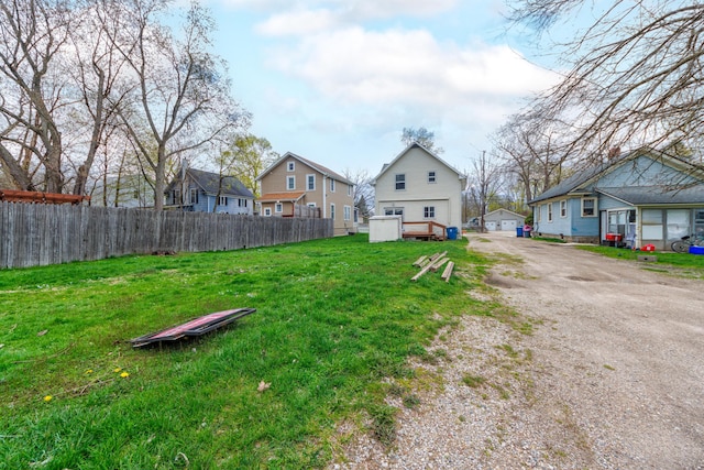 view of yard with a residential view and fence