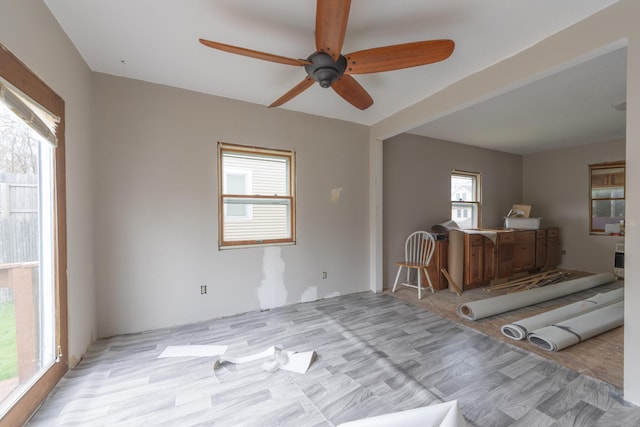 interior space with ceiling fan