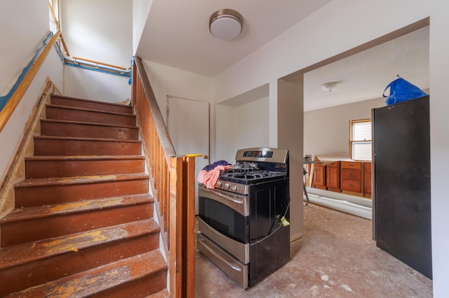 stairway with concrete flooring