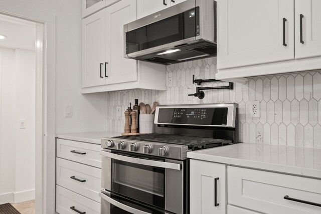 kitchen featuring light countertops, white cabinets, and stainless steel appliances