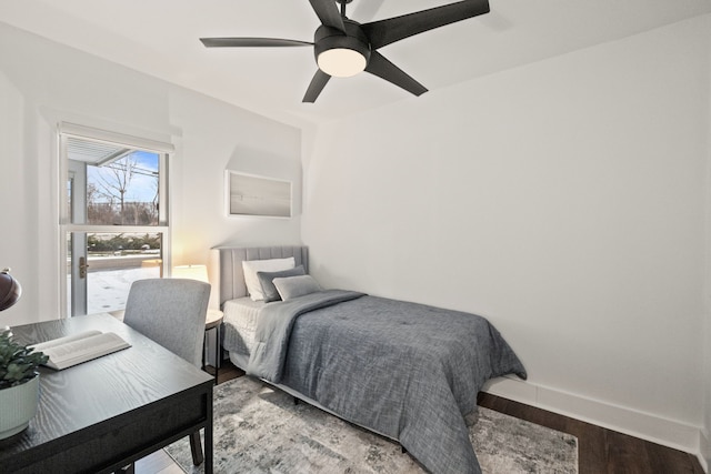 bedroom featuring wood finished floors, a ceiling fan, and baseboards