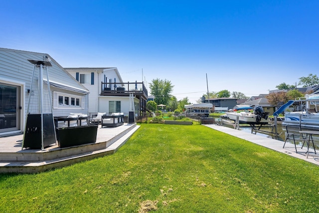 view of yard featuring an outdoor living space, a patio area, a balcony, a dock, and fence