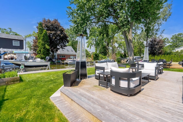 wooden deck featuring outdoor lounge area, a yard, and a dock